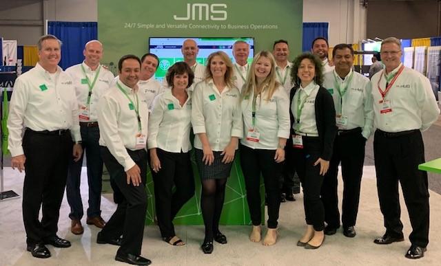 HUB Parking Technology team in front of JMS Janus Management system at IPMI 2019 in Anaheim 
